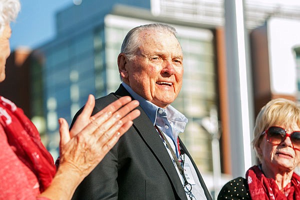 In this Sept. 13, 2014, file photo, Washington State alumnus Keith Jackson smiles after raising the Cougar flag before the start of a football game against Portland State at Martin Stadium in Pullman, Wash. Jackson, the down-home voice of college football during more than five decades as a broadcaster, died Friday. He was 89.