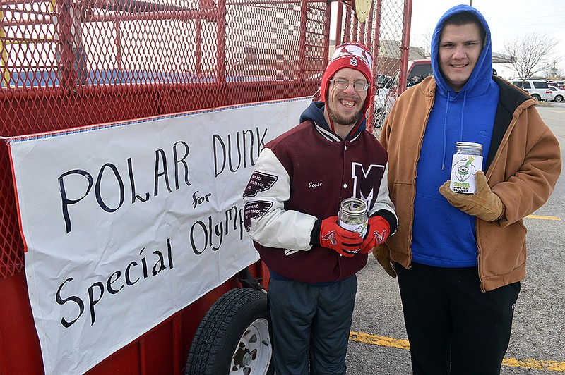 Absolute Zero Polar Plunge team members Jesse Finnell and Joshua Couch stand by the dunking booth in the Hy-Vee parking lot Saturday, hoping to raise money for Special Olympics Missouri. But Mother Nature had other plans.