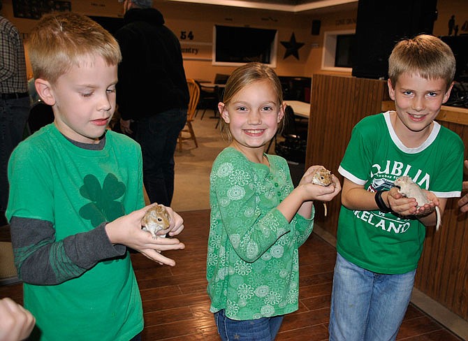 Riley Hanley, Brooklyn Keller and Will Bramon enjoy holding the mice at last year's Rotary Mouse Club Races.