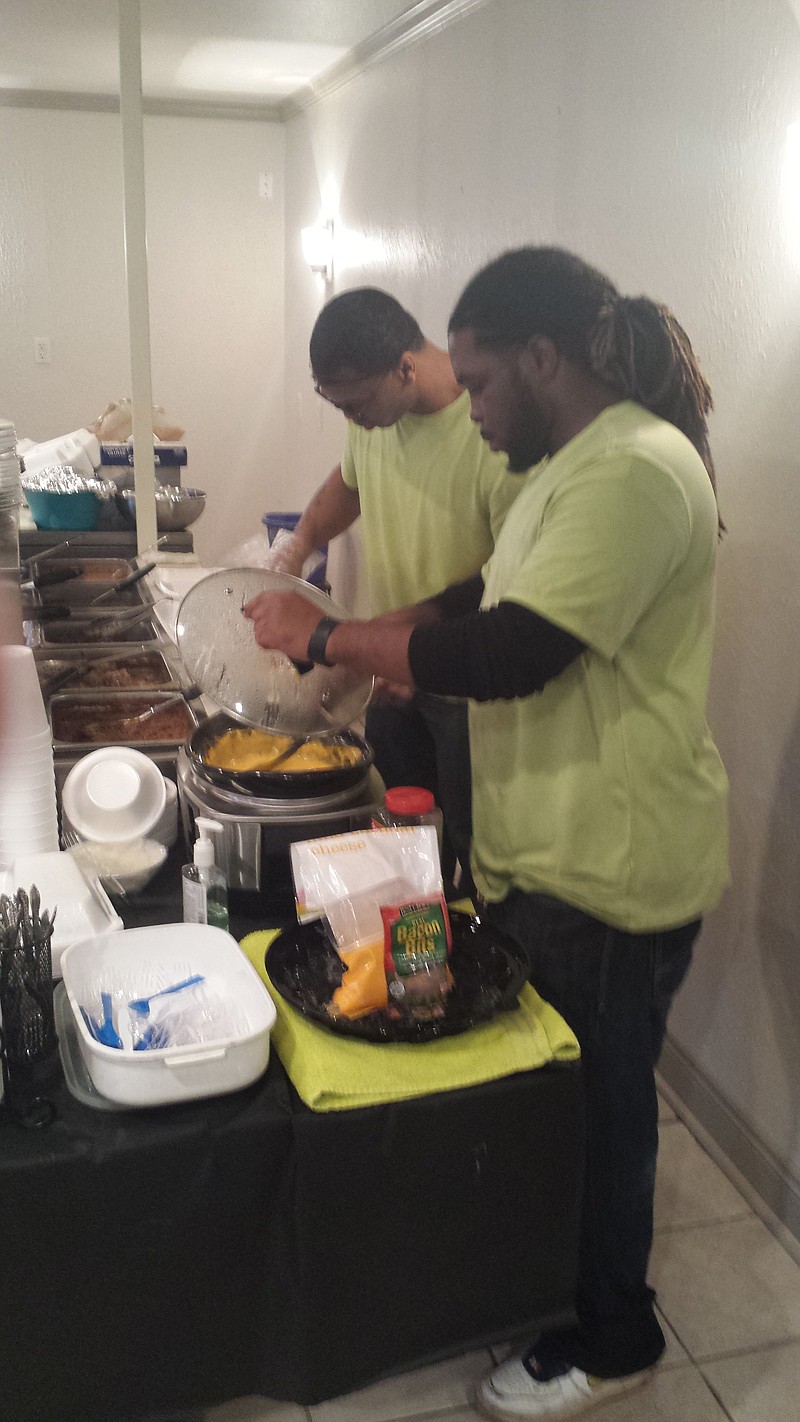 Michael Gooden and Lavert King prepare food on the serving line at Carey's Country Cooking, 607 Redwater Road in Wake Village.
