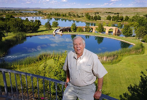 FILE - In this May 30, 2017, file photo, oil tycoon T. Boone Pickens poses for a photo before a series of man-made lakes leading from The Lake House to The Lodge on his Mesa Vista Ranch in the panhandle of Texas. Pickens announced Friday, Jan. 12, 2018, that he is closing his Dallas energy-focused hedge fund. In a statement published on LinkedIn, the 89-year-old Pickens says that "it's no secret the past year has not been good to me, from a health perspective or a financial one." (Tom Fox/The Dallas Morning News via AP, File)