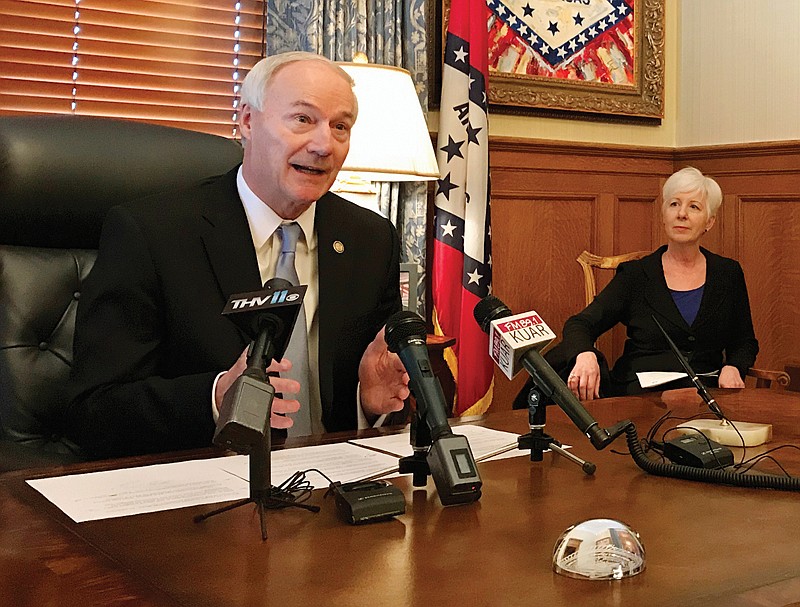 Arkansas Gov. Asa Hutchinson speaks to reporters Jan. 4 at the state Capitol in Little Rock.