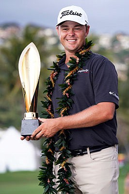 Patton Kizzire holds the Sony Open trophy after defeating James Hahn in a six-hole playoff Sunday in Honolulu.