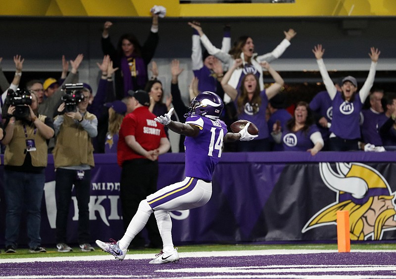 Minnesota Vikings wide receiver Stefon Riggs (14) runs in for a game-winning touchdown against the New Orleans Saints during the second half of an NFL divisional football playoff game Sunday in Minneapolis. The Vikings defeated the Saints, 29-24.