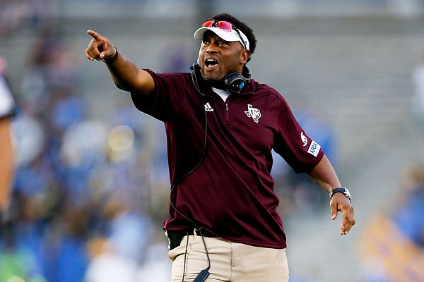In this Sept. 3, 2017, file photo, Texas A&M head coach Kevin Sumlin gestures during a game against UCLA, in Pasadena, Calif.