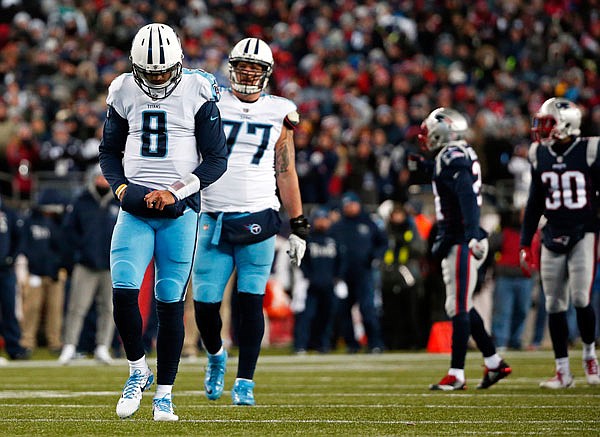 Titans quarterback Marcus Mariota walks on the field during the first half of Saturday's AFC divisional playoff game against the Patriots in Foxborough, Mass.