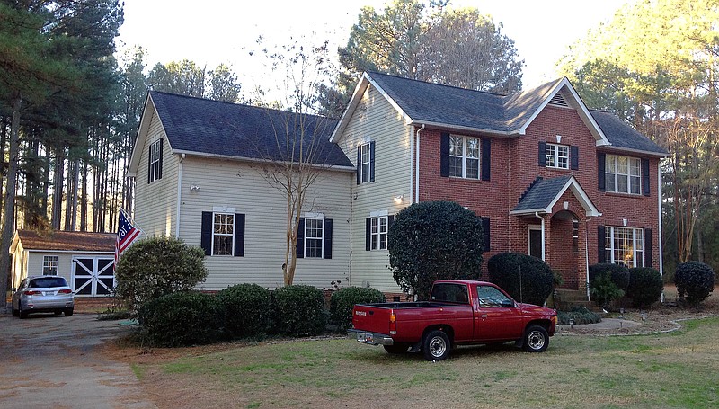 Cars are parked at a home in York, S.C. on Tuesday, Jan. 16, 2018, where multiple deputies responding to a domestic violence call were shot and wounded. State Law Enforcement Division spokesman Thom Berry said Christian Thomas McCall is the man officers think shot and wounded the officers early Tuesday. (AP Photo/Jeffrey S. Collins)