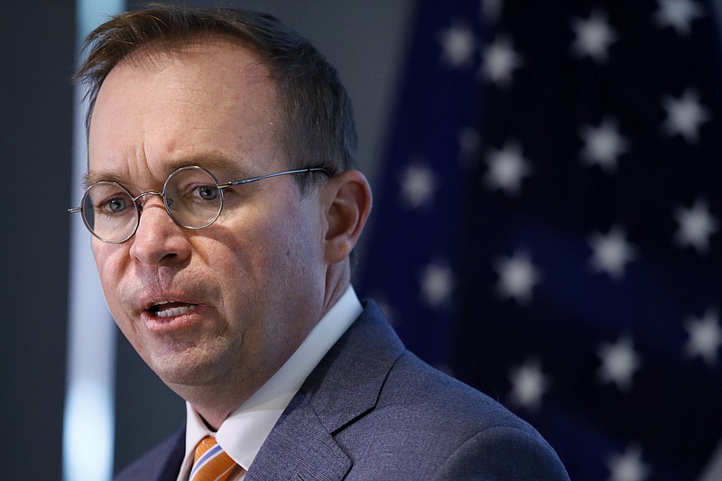 FILE - In this Monday, Nov. 27, 2017, file photo, Mick Mulvaney speaks during a news conference after his first day as acting director of the Consumer Financial Protection Bureau in Washington. The CFPB is reconsidering a key set of rules enacted in 2017 that would have protected consumers against harmful payday lenders. The bureau, now under Trump administration control, says it plans to take a second look at rules put in place last year under an Obama appointee. (AP Photo/Jacquelyn Martin, File)