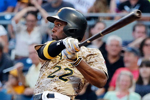 In this Aug. 3, 2017, file photo, Pirates outfielder Andrew McCutchen watches his RBI-single off Reds starting pitcher Sal Romano during the third inning of a game in Pittsburgh. The Giants acquired McCutchen from the Pirates for right-hander Kyle Crick, minor league outfielder Bryan Reynolds and $500,000 in international signing bonus allocation.