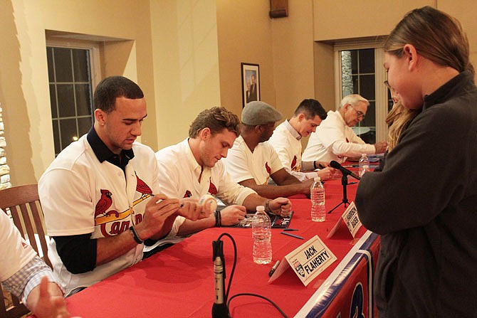 Current and former St. Louis Cardinals players sign autographs for fans Saturday evening during a visit to Fulton.