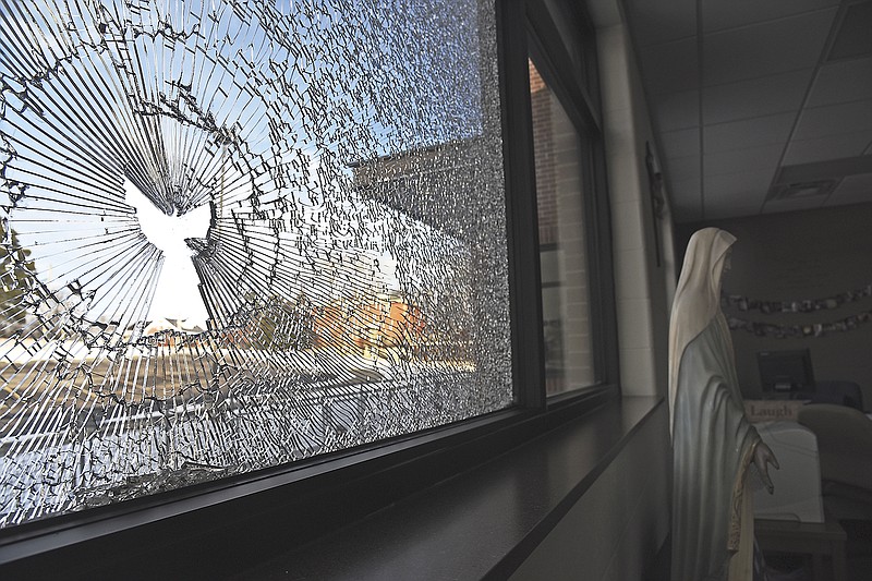 Several windows at Helias High School were recently vandalized, including this office window. The glass breakage in this particular window resulted in the shape of a robed angel with wings extended.