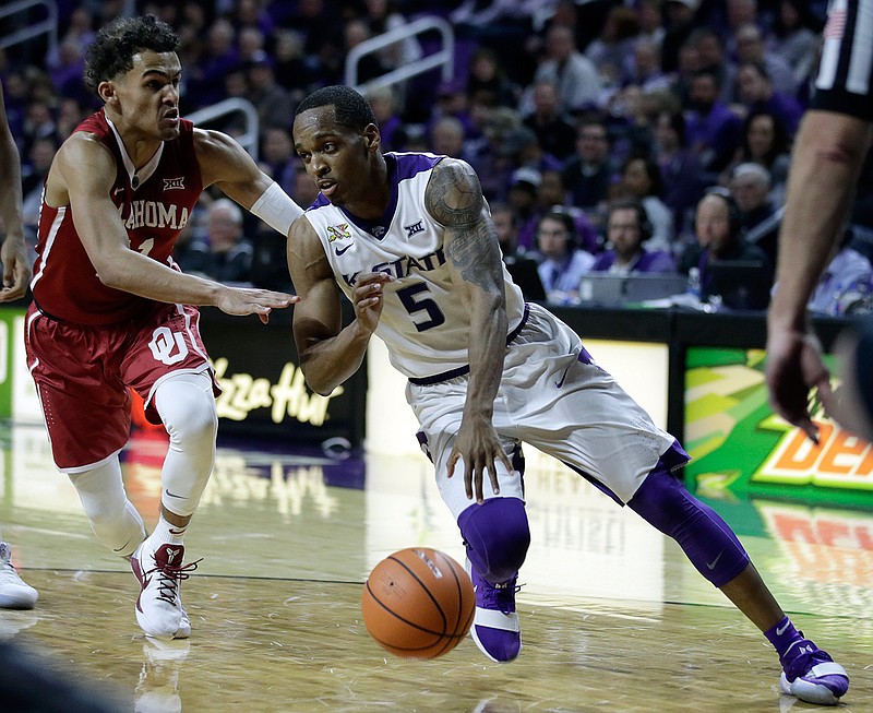 Kansas State guard Barry Brown (5) drives on Oklahoma guard Trae Young (11) during the second half of an NCAA college basketball game in Manhattan, Kan., Tuesday, Jan. 16, 2018. 
