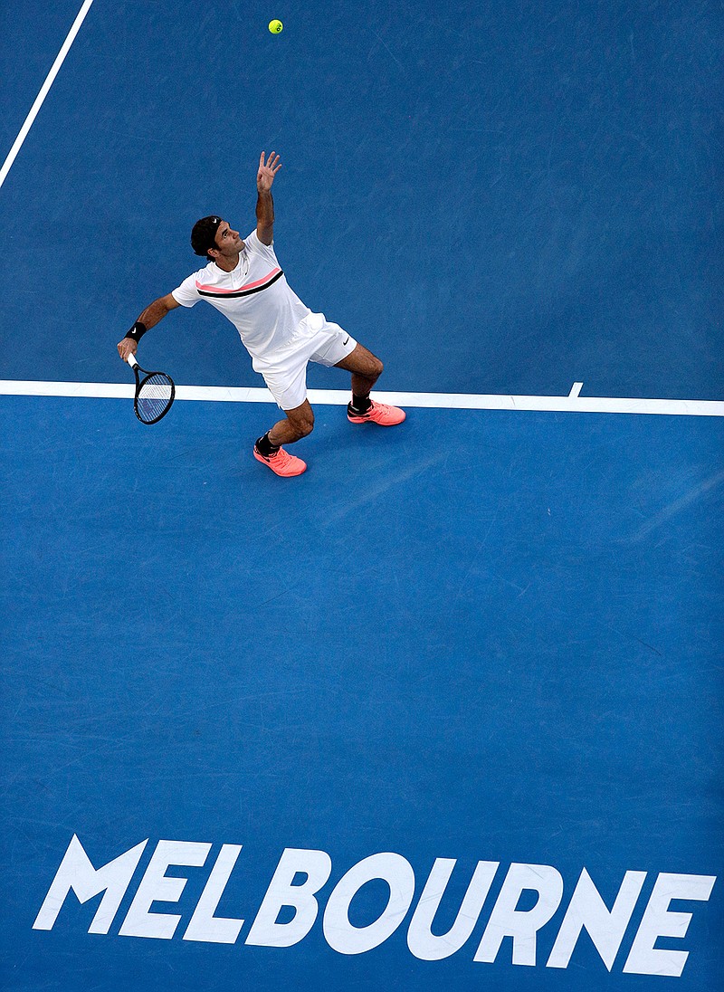 Switzerland's Roger Federer serves to Slovenia's Aljaz Bedene during their first round match at the Australian Open tennis championships in Melbourne, Australia, Tuesday, Jan. 16, 2018. 