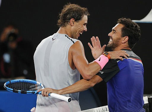 Spain's Rafael Nadal, left, is congratulated by Victor Estrella Burgos of the Dominican Republic during their first round match at the Australian Open tennis championships in Melbourne, Australia, Monday, Jan. 15, 2018. 