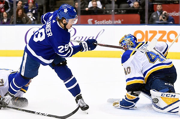 Blues goaltender Carter Hutton makes a pad save on a shot by William Nylander of the Maple Leafs on the breakaway during overtime Tuesday night in Toronto.