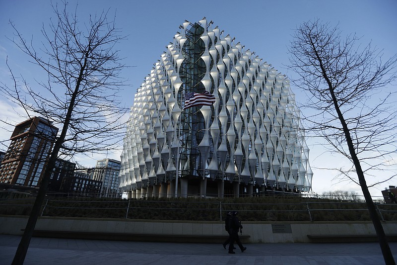 Armed British police officers patrol around the new United States Embassy building in London, Tuesday, Jan. 16, 2018. The new U.S. Embassy in London, denigrated last week by President Donald Trump as too expensive and in a poor location, is set to open to the public. The embassy, in the formerly industrial Nine Elms neighborhood, will open for public business Tuesday.