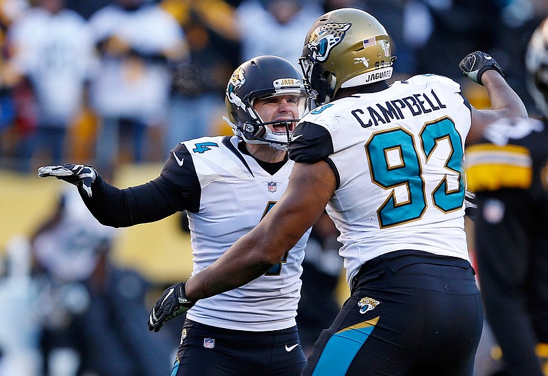 Jacksonville Jaguars kicker Josh Lambo (4) celebrates with Calais Campbell (93) after kicking a field goal during the second half of an NFL divisional football AFC playoff game against the Pittsburgh Steelers in Pittsburgh, Sunday, Jan. 14, 2018. The Jaguars won 45-42.