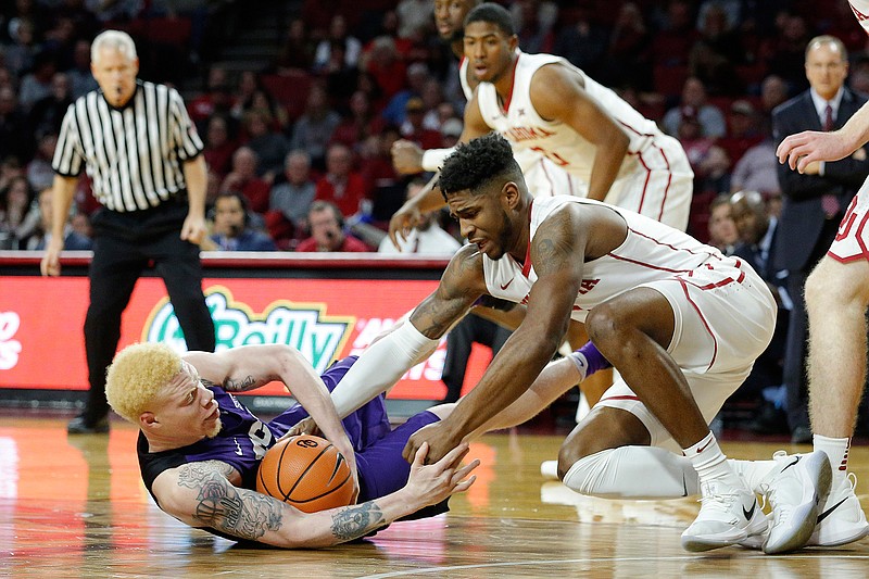 TCU's Jaylen Fisher (0) fights for the ball with Oklahoma's Rashard Odomes (1) during the first half of an NCAA college basketball game in Norman, Okla., Saturday, Jan. 13, 2018. 