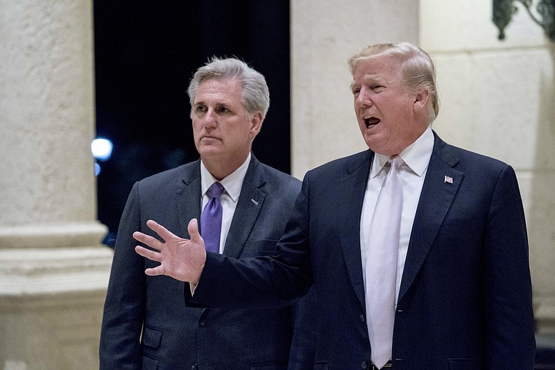 In this Jan. 14, 2018 photo, President Donald Trump, right, accompanied by House Majority Leader Kevin McCarthy, R-Calif., speaks to members of the media as they arrive for a dinner at Trump International Golf Club in West Palm Beach, Fla. Reinforcing its standing with social conservatives, the Trump administration creates a federal office to protect medical providers who refuse to participate in abortion, assisted suicide or other procedures because of their moral or religious beliefs.  (AP Photo/Andrew Harnik)