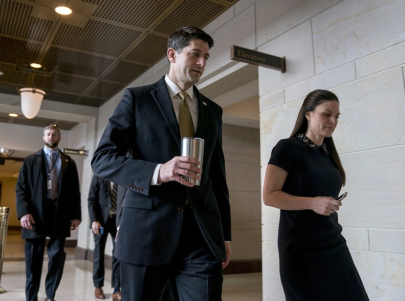 House Speaker Paul Ryan of Wis., center, accompanied by his Press Secretary AshLee Strong, right, walks to the Capitol Building from the Capitol Visitor's Center, Thursday, Jan. 18, 2018, in Washington. (AP Photo/Andrew Harnik)