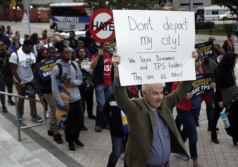 Frank Corbishley, of Coral Gables, Fla., marches in support of Deferred Action for Childhood Arrivals (DACA) and Temporary Protected Status (TPS) programs Wednesday, Jan. 17, 2018, in Miami. (AP Photo/Lynne Sladky)