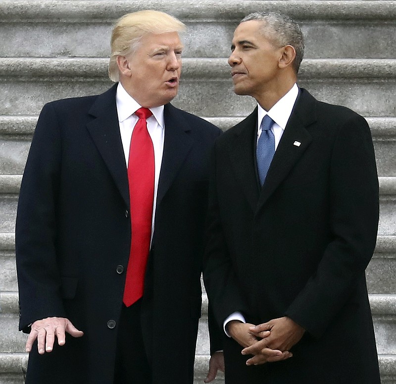 FILE - In this Friday, Jan. 20, 2017, file photo, President Donald Trump talks with former President Barack Obama on Capitol Hill in Washington, prior to Obama's departure to Andrews Air Force Base, Md. Trump relentlessly congratulates himself for the healthy state of the U.S. economy. But in the year since Trump’s inauguration, most analysts tend to agree on this: The economy remains essentially the same sturdy one he inherited from Obama. (Rob Carr/Pool Photo via AP, File)
