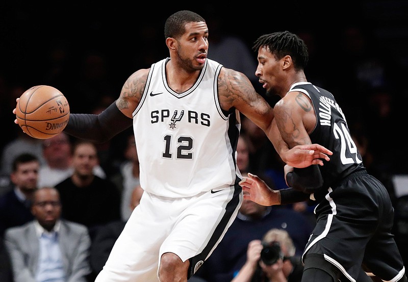 Brooklyn Nets' Rondae Hollis-Jefferson (24) defends San Antonio Spurs' LaMarcus Aldridge (12) during the first half of an NBA basketball game Wednesday, Jan. 17, 2018, in New York. (AP Photo/Frank Franklin II)