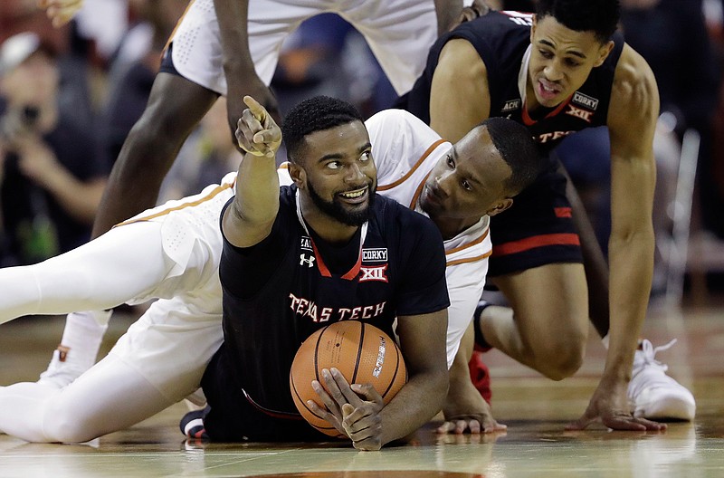 Texas Tech guard Niem Stevenson (10) signals position after he and Texas guard Matt Coleman, center, battled for control of the ball during the first half of an NCAA college basketball game, Wednesday, Jan. 17, 2018, in Austin, Texas. (AP Photo/Eric Gay)