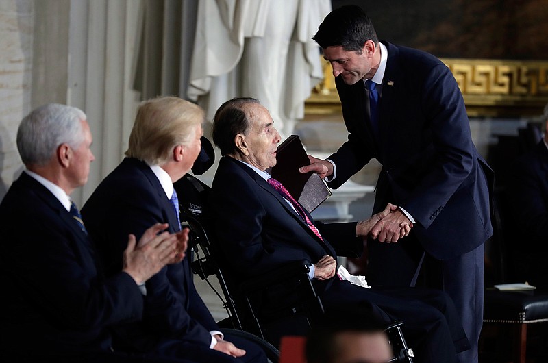 President Donald Trump and Vice President Mike Pence watch as House Speaker Paul Ryan of Wis., greets former Sen. Bob Dole during a Congressional Gold Medal ceremony honoring Dole on Capitol Hill, Wednesday, Jan. 17, 2018, in Washington. (AP Photo/Evan Vucci)