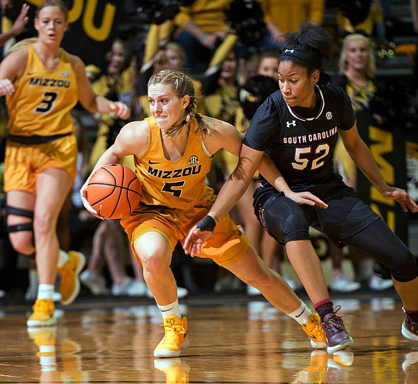 Missouri's Lauren Aldridge dribbles away from South Carolina's Tyasha Harris during the second half of a game earlier this month at Mizzou Arena in Columbia. The Tigers, ranked No. 11 in the AP poll, play today at Mississippi. Game time is 8 p.m.