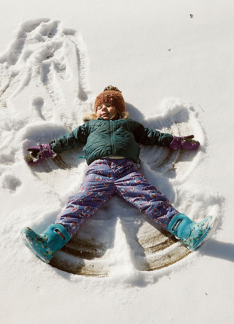 Greer Glover, 3, makes a snow angel Wednesday, Jan. 17, 2018, at Ansley Golf in Atlanta. She was there with her mother, Melissa. With temperatures in the teens, overnight snowfall is expected to remain into Thursday. Gov. Deal declared a state of emergency in 83 Georgia counties for Wednesday, Jan. 17. (Bob Andres/Atlanta Journal-Constitution via AP)