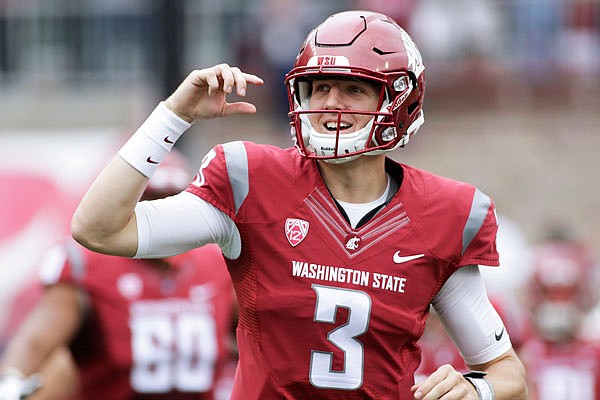 In this Sept. 17, 2016 file photo, Washington State quarterback Tyler Hilinski runs onto the field with his teammates before a game against Idaho in Pullman, Wash. Hilinski died from an apparent self-inflicted gunshot wound and was discovered in his apartment after he didn't show up for practice Tuesday.