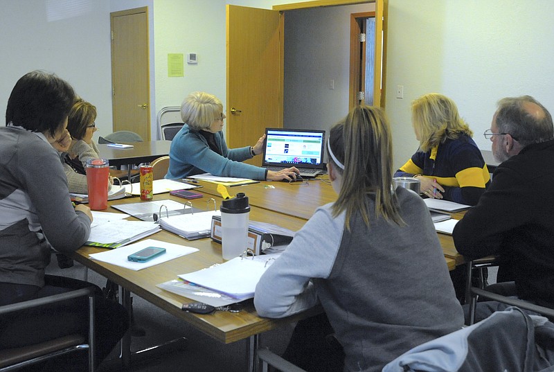 <p>Democrat photo/Michelle Brooks</p><p>Members of the Moniteau County Library Board look at new online services, which they approved at the board’s first meeting Jan. 18 meeting. Pictured are Sara Rohrbach, President Laura Burger, Director Connie Walker, Holly Bieri, Lana Dicus and Bill Boies.</p>