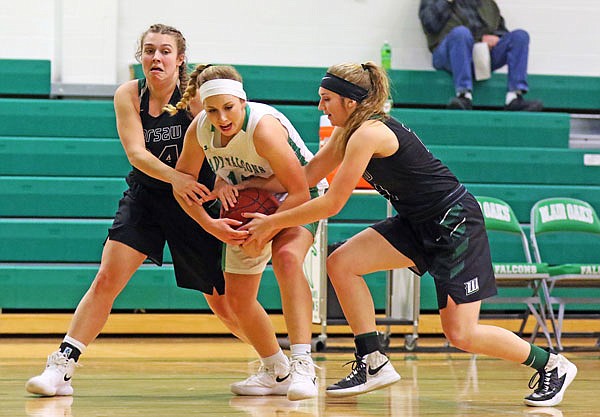 Sydney Wilde of Blair Oaks tries to keep the ball away from Warsaw teammates Jordan Plybon (left) and Aubrie McRoberts following a steal during the first half of Thursday night's game in Wardsville.