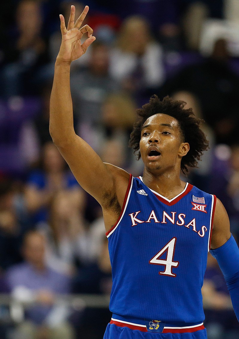 In this Jan. 6, 2018, file photo, Kansas guard Devonte' Graham (4) reacts after sinking a three-point shot against TCU during the second half of an NCAA college basketball game, in Fort Worth, Texas. The hallmarks of Kansas under Bill Self have been inside-outside post play and gritty defense. Three-pointers were "fool's gold" and out-running teams was the stuff of Roy Williams. Well, look who is relying on 3-pointers and piling up points these days. (AP Photo/Ron Jenkins)