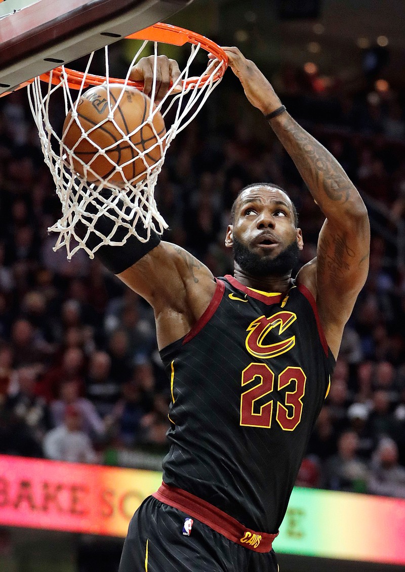 Cleveland Cavaliers' LeBron James dunks against the Golden State Warriors in the first half of an NBA basketball game, Monday, Jan. 15, 2018, in Cleveland. (AP Photo/Tony Dejak)