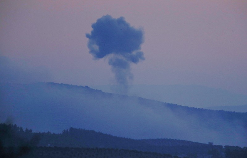 Plumes of smoke rise on the air from inside Syria, as seen from the outskirts of the border town of Kilis, Turkey, Saturday, Jan. 20, 2018. Turkish jets have begun an aerial offensive, codenamed operation "Olive Branch", against the Syrian Kurdish-held enclave of Afrin, in northwest Syria . A military statement says the operation launched Saturday aims to protect Turkey's borders, "neutralize" Syrian Kurdish fighters in the enclave and to save the local population from their "pressure and oppression." (AP Photo/Lefteris Pitarakis)