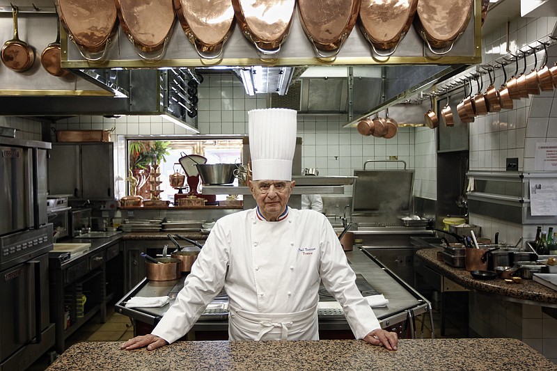 FILE - In this March 24, 2011 file French Chef Paul Bocuse poses outside his famed Michelin three-star restaurant L'Auberge du Pont de Collonges in Collonges-au-Mont-d'or, central France. French interior minister announces Saturday Jan.20, 2018 that Paul Bocuse, a master of French cuisine, has died at 91. (AP Photo/Laurent Cipriani, File)