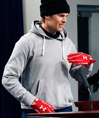 Patriots quarterback Tom Brady wears gloves as he arrives to speak to the media Friday in Foxborough, Mass.