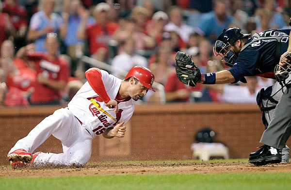 Randal Grichuk scores a run for the Cardinals during a 2015 game against the Braves at Busch Stadium.