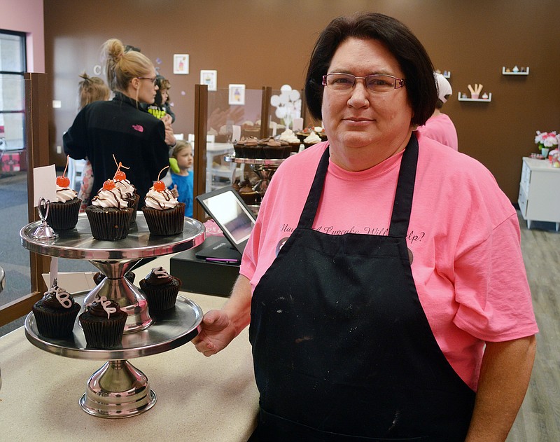 Mark Wilson/News Tribune
Smallcakes Cupcakery owner Lisa Altamam works in her store Friday. The new bakery is located at 905 Eastland Drive.