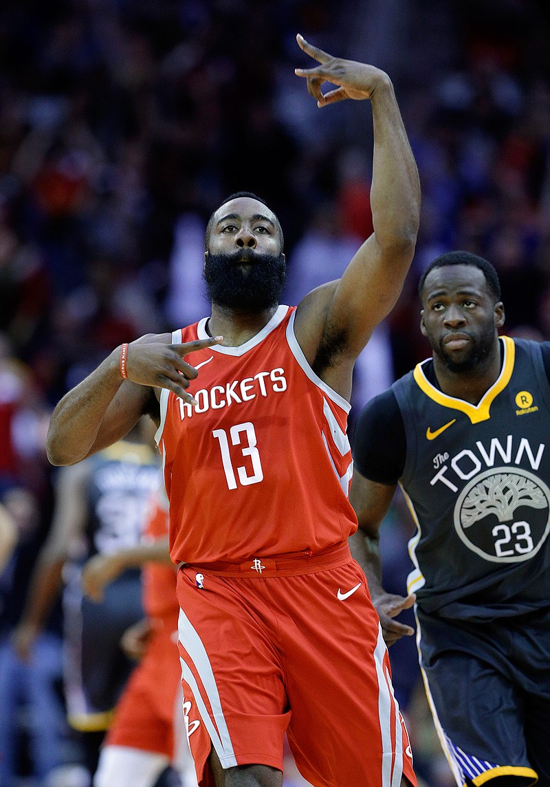 Houston Rockets guard James Harden (13) celebrates a three point shot as Golden State Warriors forward Draymond Green (23) looks on during the first half of an NBA basketball game Saturday, Jan. 20, 2018, in Houston. (AP Photo/Michael Wyke)