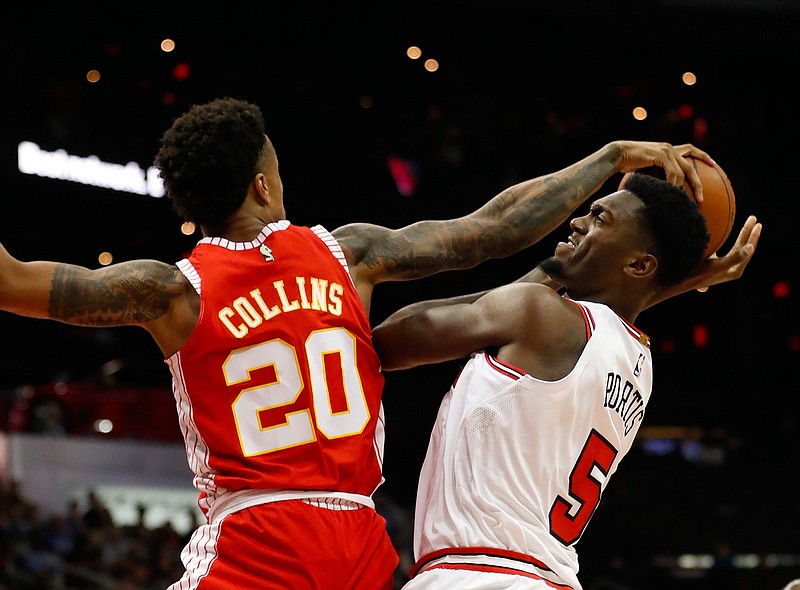 Chicago Bulls forward Bobby Portis (5) is defended by as he tries to score Atlanta Hawks forward John Collins (20) during the second half of an NBA basketball game Saturday, Jan. 20, 2018, in Atlanta. Chicago won 113-97. (AP Photo/John Bazemore)