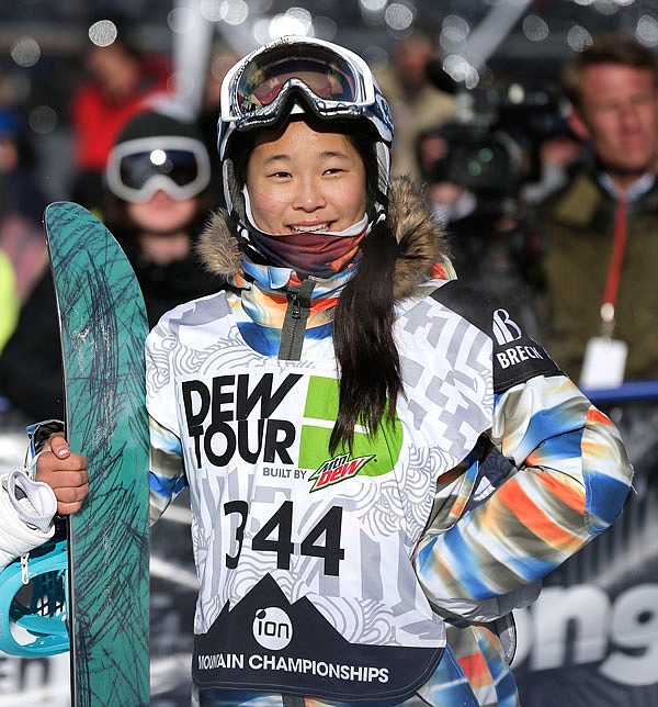 In this Dec. 14, 2013, file photo, Chloe Kim watches the replay of her second run during the snowboarding superpipe final at the Dew Tour iON Mountain Championships in Breckenridge, Colo.  Kim is the favorite to win the Olympic halfpipe contest being held in South Korea, the country where her parents grew up.