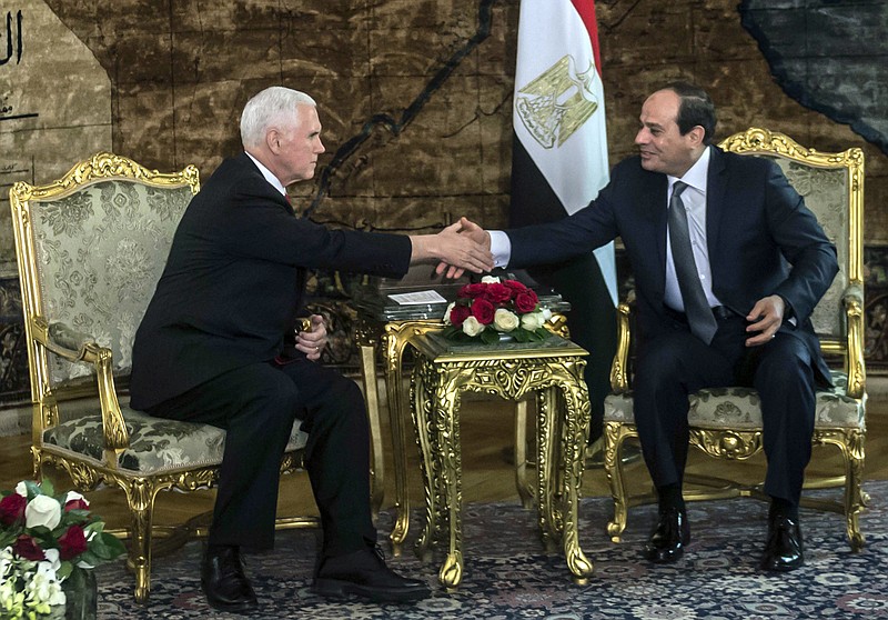 U.S. Vice President Mike Pence shakes hands with Egyptian President Abdel-Fattah el-Sissi, right, at the Presidential Palace in Cairo, Egypt, Saturday, Jan. 20, 2018. Pence arrived in Cairo hours after the U.S. Congress and President Donald Trump failed to reach agreement on a plan to avert a partial federal closure. Pence went ahead with his four-day trip to the Middle East, citing national security and diplomatic reasons. (Khaled Desouki/Pool Photo via AP)