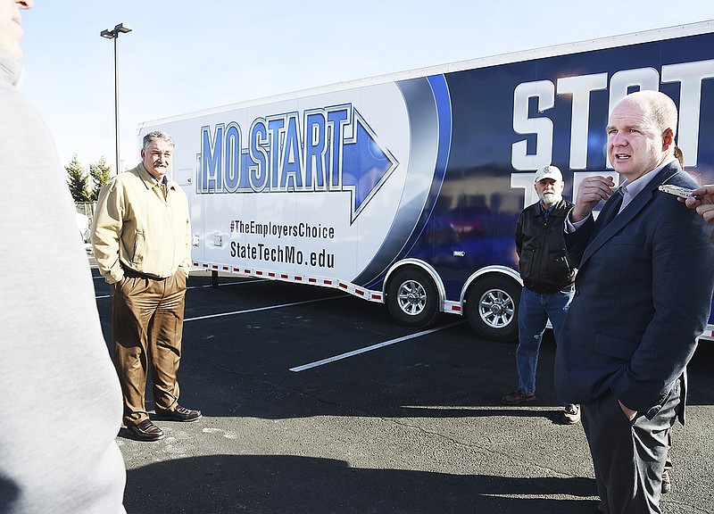 State Technical College President Shawn Strong, right, talks Friday, Jan. 19, 2018, about the abilities for outreach the college will now have with the acquisition of this MOSTART trailer.