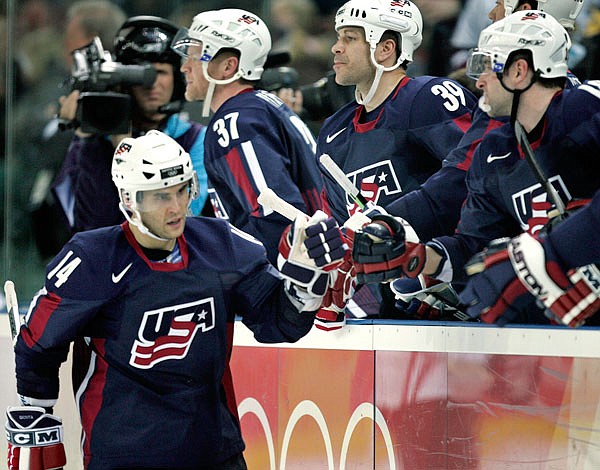 In this Feb. 15, 2006, file photo, United States' Brian Gionta is congratulated by teammates after scoring against Latvia during a 2006 Winter Olympics game in Turin, Italy.