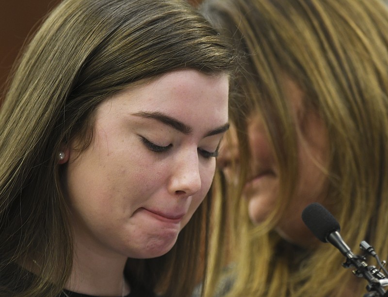 Emma Ann Miller, 15, speaks  Monday, Jan. 22, 2018, during the fifth day of victim impact statements against Larry Nassar in Ingham County Circuit Court in Lansing, Mich. Nassar will be sentenced on sexual assault charges this week. Next to her is her mother Leslie. Nassar has admitted molesting athletes during treatment when he was employed by Michigan State University and USA Gymnastics, which trains Olympians. He will be sentenced on sexual assault charges this week.  (Matthew Dae Smith/Lansing State Journal via AP)