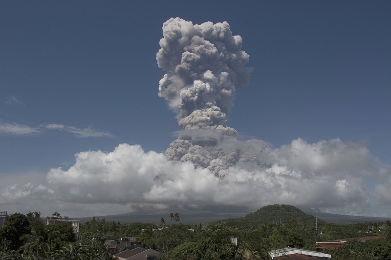 A huge column of ash shoots up to the sky during the eruption of Mayon volcano Monday, Jan. 22, 2018 as seen from Legazpi city, Albay province, around 340 kilometers (200 miles) southeast of Manila, Philippines. The Philippines' most active volcano erupted Monday prompting the Philippine Institute of Volcanology and Seismology to raise the Alert level to 4 from last week's alert level 3. (AP Photo/Earl Recamunda)