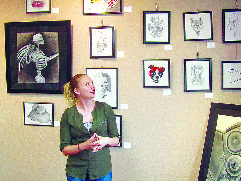 Local artist Kate Johnson gives a presentation about her artwork Sunday at Capital Arts. She is the featured artist for the gallery's Shadows & Relections exhibit, which runs through Feb. 14.